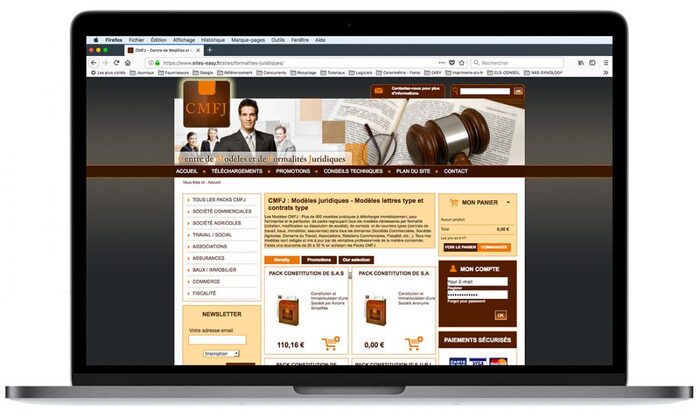 Mockup réaliste du site e-commerce CMFJ affiché sur un ordinateur portable Apple