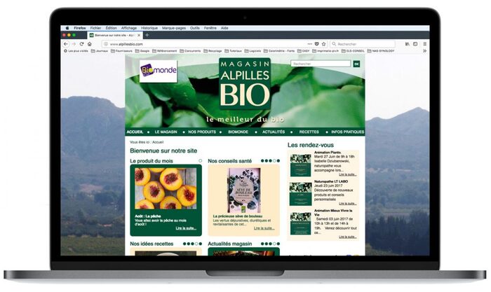 Visuel du site Alpilles Bio sur un ordinateur portable Apple, mettant en valeur les produits bio et l’esprit commerce local